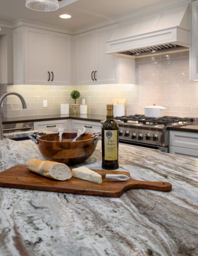 A kitchen with a marble counter top.