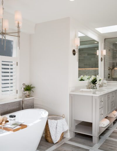 A white bathroom with a large tub and sink.