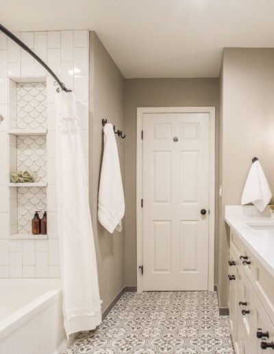 A white and black bathroom with a tub and sink.