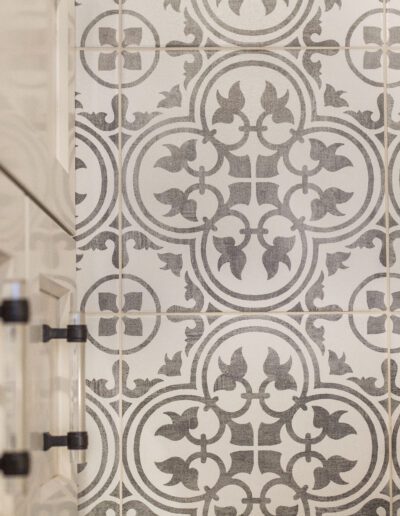 A bathroom with a tiled wall.