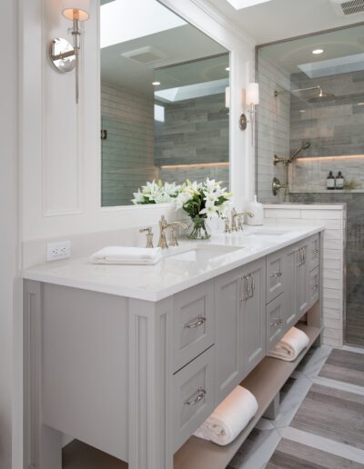 A bathroom with two sinks and a mirror.