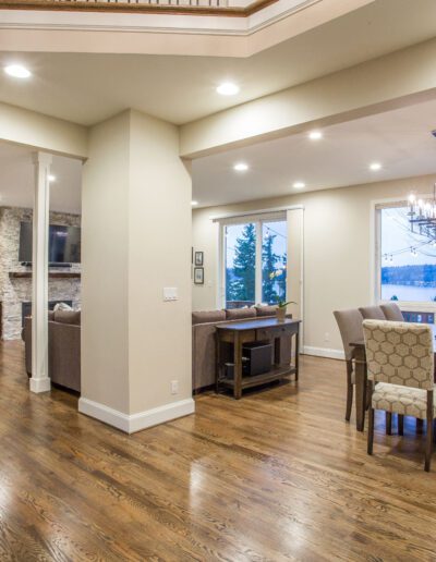 A living room with hardwood floors and a dining table.