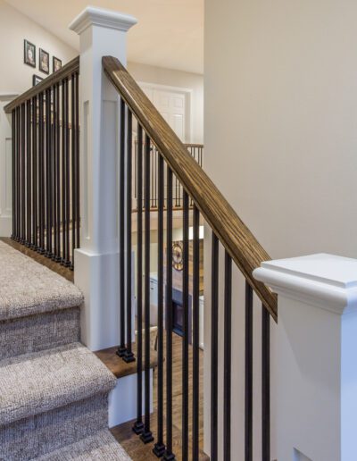 A stair railing in a home with hardwood floors.