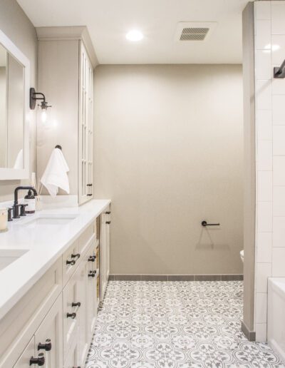 A white and black bathroom with a tub and sink.