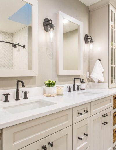 A white bathroom with two sinks and mirrors.