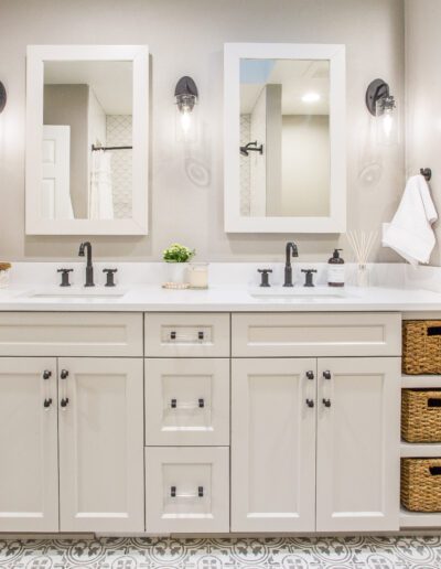 A bathroom with white cabinets and baskets.