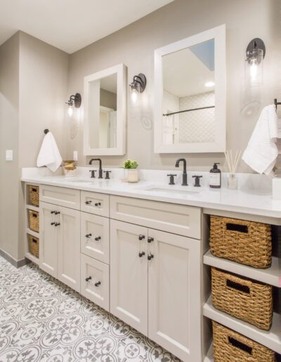 A white and gray bathroom with wicker baskets.