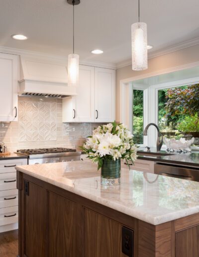 A kitchen with white cabinets and a center island.